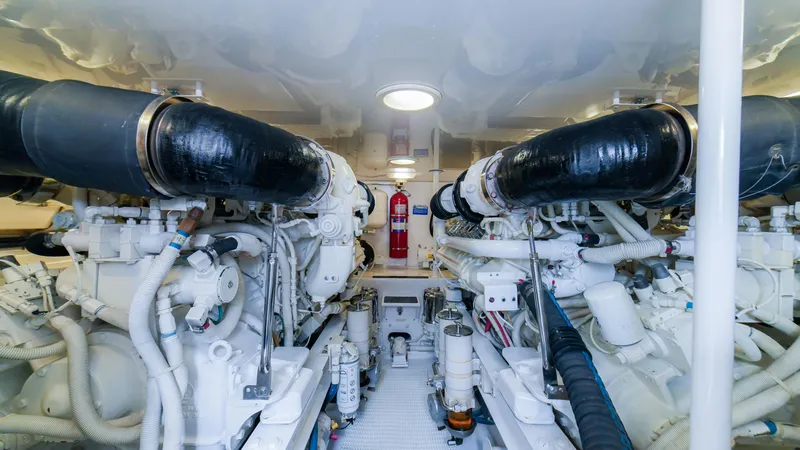 Manudito Yacht Photos Pics Engine room of a 2009 Viking 50C yacht with dual engines and fire extinguisher.