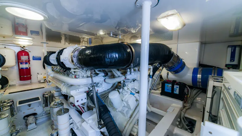 Manudito Yacht Photos Pics Engine room of a 2009 Viking 50C yacht with visible machinery and fire extinguisher.