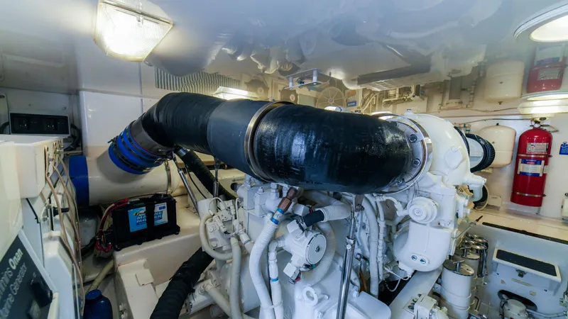 Manudito Yacht Photos Pics Engine room of a 2009 Viking 50C boat with visible machinery and equipment.