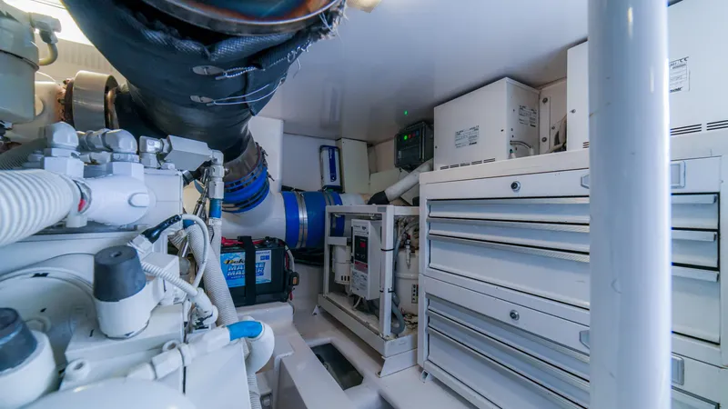 Manudito Yacht Photos Pics Engine room of a 2009 Viking 50C yacht with various mechanical components.