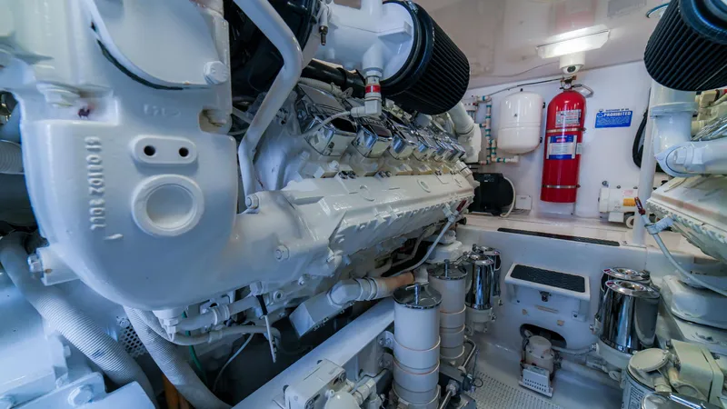 Manudito Yacht Photos Pics Engine room of a 2009 Viking 50C yacht with visible machinery and fire extinguisher.