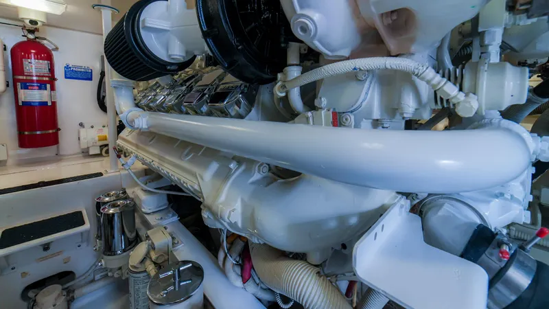 Manudito Yacht Photos Pics Engine room of a 2009 Viking 50C yacht with visible fire extinguisher.