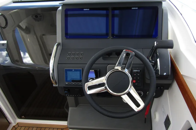  Yacht Photos Pics Steering console of 2025 Nimbus Weekender 9 boat with dual Simrad displays.