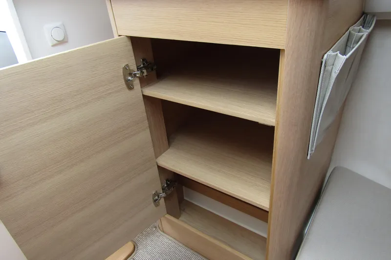  Yacht Photos Pics Open wooden cabinet with shelves inside a 2025 Nimbus Weekender 9.