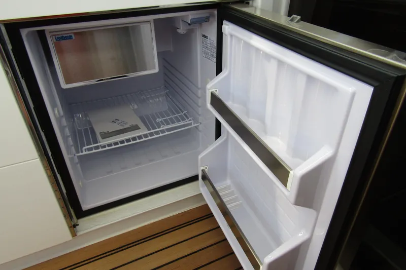  Yacht Photos Pics Open refrigerator inside Nimbus Weekender 9, 2025 model, with empty shelves and door compartments.