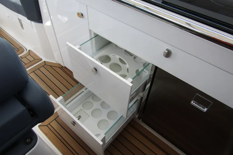  Yacht Photos Pics Interior of 2025 Nimbus Weekender 9 with open storage drawers and wood flooring.