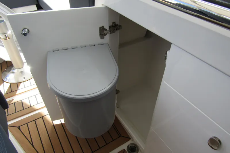  Yacht Photos Pics Open cabinet with trash bin on Nimbus Weekender 9, 2025 model.
