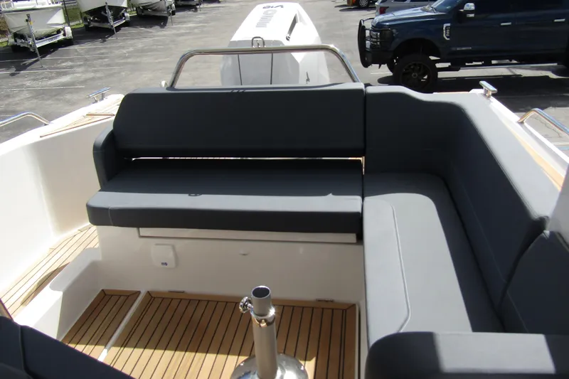  Yacht Photos Pics 2025 Nimbus Weekender 9 boat interior with gray seating and wooden flooring.