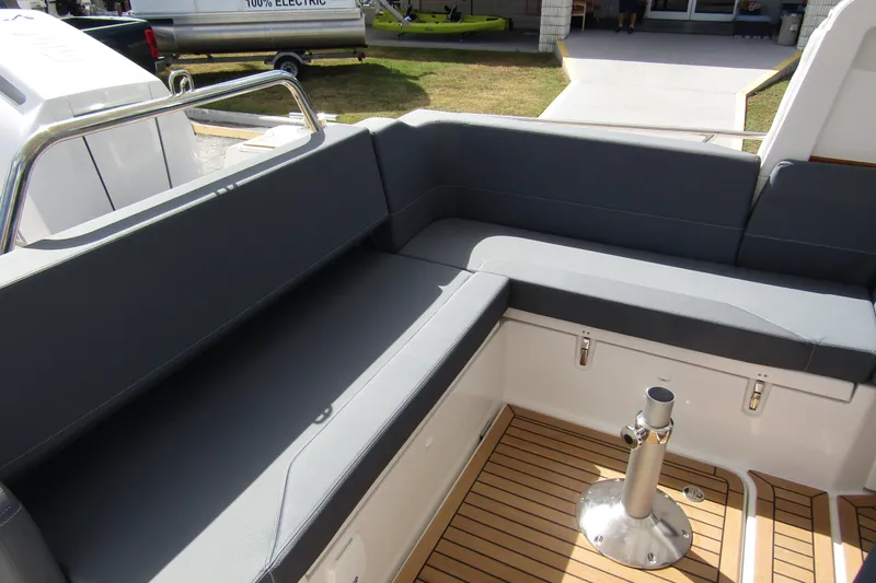  Yacht Photos Pics Luxurious seating area on 2025 Nimbus Weekender 9 boat with sleek design and wooden flooring.