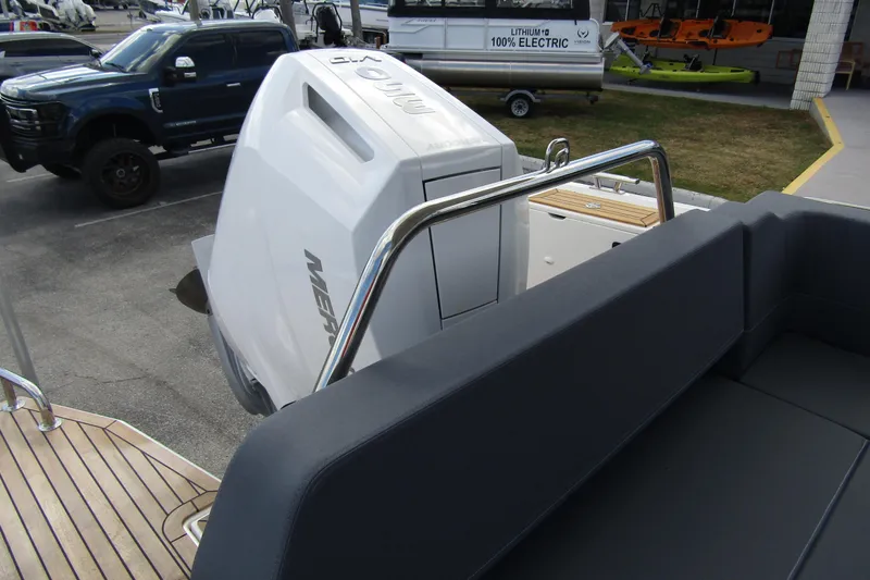  Yacht Photos Pics 2025 Nimbus Weekender 9 boat with Mercury engine, parked near electric vehicle.