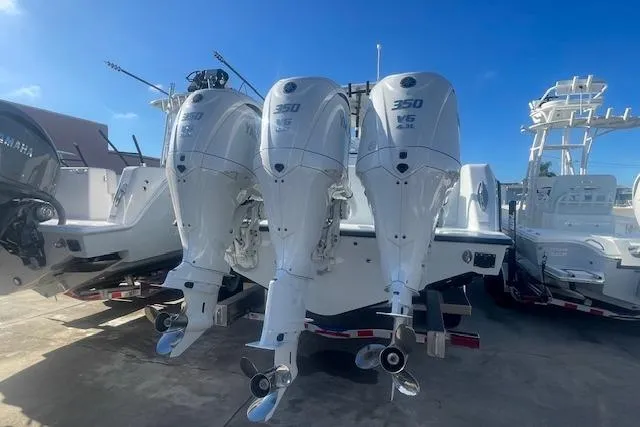  Yacht Photos Pics 2026 Contender 39 ST boat with triple 350 V6 outboard engines, docked under clear blue sky.