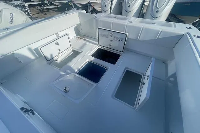  Yacht Photos Pics 2026 Contender 39 ST boat deck with open storage compartments and Yamaha engines.