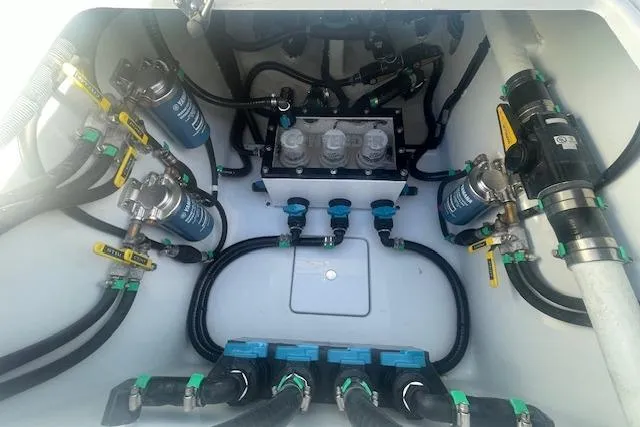  Yacht Photos Pics Engine compartment of 2026 Contender 39 ST boat, showcasing complex wiring and filtration systems.