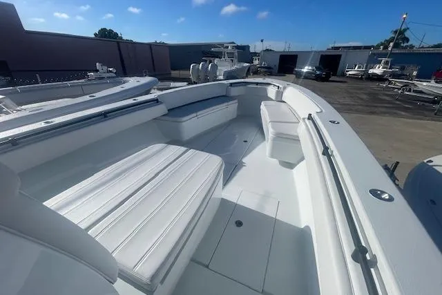  Yacht Photos Pics 2026 Contender 39 ST boat with spacious seating, docked outdoors under a clear sky.