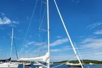 Sailboat Rustler 33, 2017 model, on calm waters under a clear blue sky.