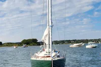 Sailboat Rustler 33, 2017 model, anchored on a sunny day with blue skies.