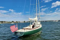 Sailboat Rustler 33 (2017) named "Julia" with American flag on calm waters.