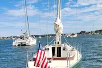 Sailboat "Julia" in Westport, MA harbor, Rustler 33 model, 2017, with American flag.