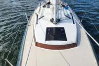 Sailboat deck view of 2017 Rustler 33 on water, showcasing mast and hatch.