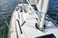 Sailboat deck view of 2017 Rustler 33 on water, featuring rigging and mast.