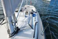 Sailing yacht Rustler 33, 2017 model, on calm waters with visible deck and rigging.