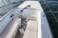 2017 Rustler 33 sailboat cockpit with American flag, docked in a marina.