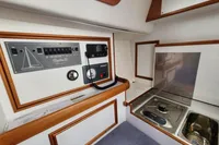 Interior of 2017 Rustler 33 yacht with control panel and compact kitchen area.