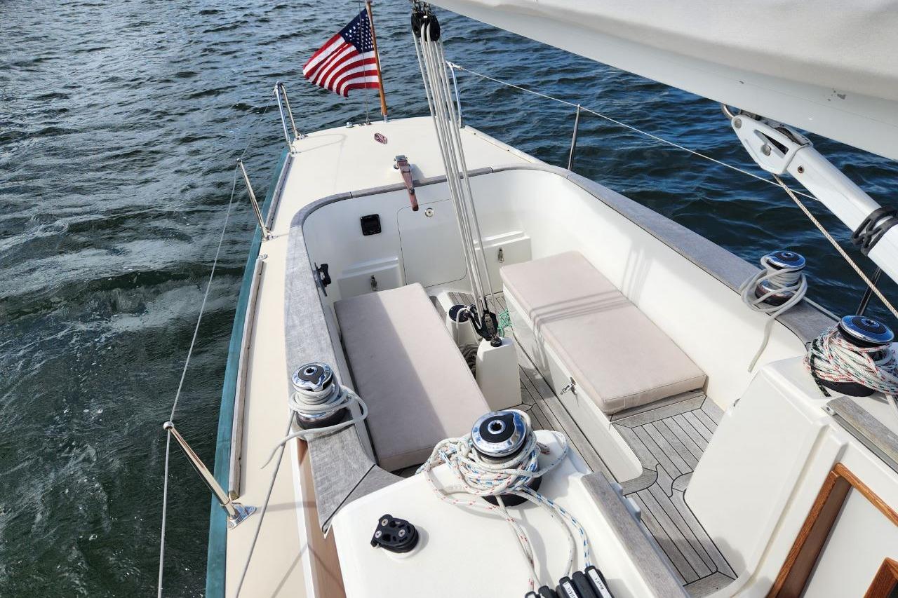 2017 Rustler 33 sailboat cockpit with American flag on open water.