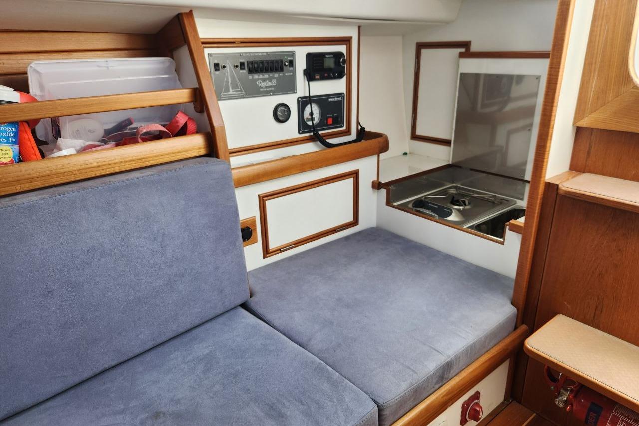 Interior of a 2017 Rustler 33 sailboat with seating and control panel.