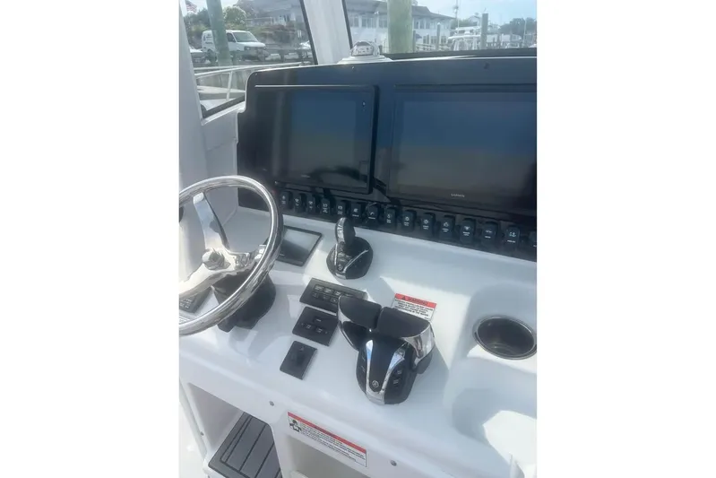  Yacht Photos Pics Control panel of 2021 Sea Hunt Gamefish 27 Coffin Box with dual screens and steering wheel.