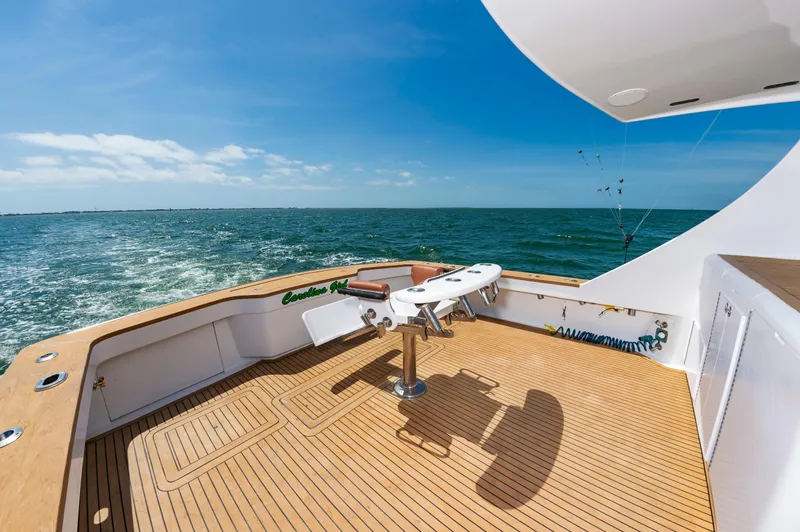 Carolina Girl Yacht Photos Pics 1993 Jarrett Bay Convertible yacht deck with ocean view, featuring fishing equipment and teak flooring.