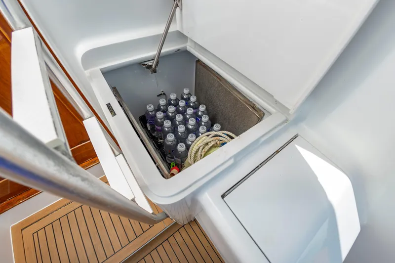 Carolina Girl Yacht Photos Pics Storage compartment on 1993 Jarrett Bay Convertible boat with drinks and rope.