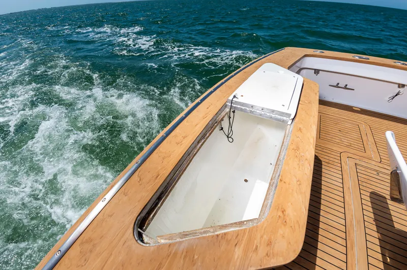 Carolina Girl Yacht Photos Pics 1993 Jarrett Bay Convertible boat deck with open hatch, cruising on the ocean.