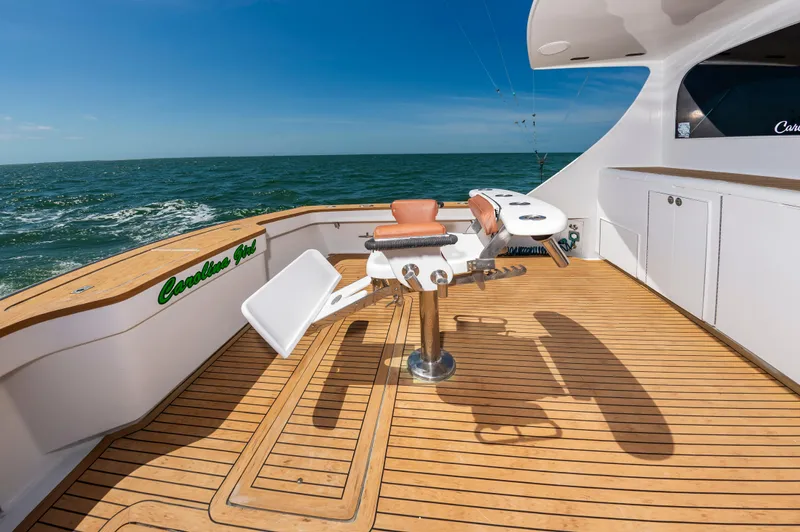 Carolina Girl Yacht Photos Pics 1993 Jarrett Bay Convertible yacht deck with fishing chair, ocean view, and clear blue sky.