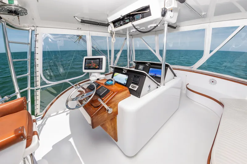 Carolina Girl Yacht Photos Pics 1993 Jarrett Bay Convertible yacht helm with ocean view, featuring modern navigation equipment.