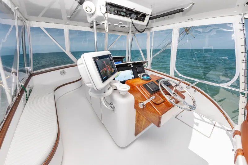 Carolina Girl Yacht Photos Pics Helm of 1993 Jarrett Bay Convertible boat with ocean view and navigation equipment.