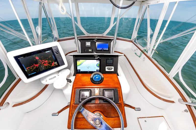 Carolina Girl Yacht Photos Pics Cockpit of 1993 Jarrett Bay Convertible boat with navigation equipment and ocean view.