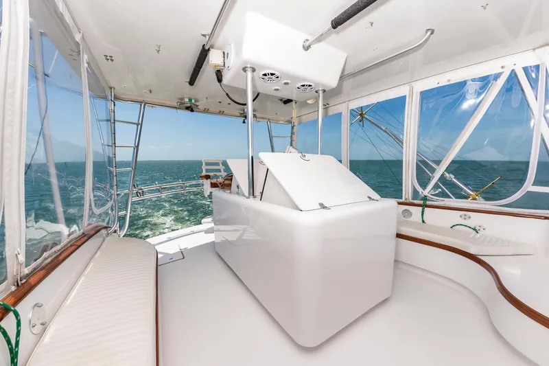 Carolina Girl Yacht Photos Pics 1993 Jarrett Bay Convertible yacht interior with ocean view, featuring sleek white design and seating.