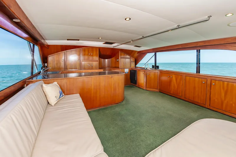 Carolina Girl Yacht Photos Pics Luxurious 1993 Jarrett Bay Convertible yacht interior with wooden cabinetry and ocean view.