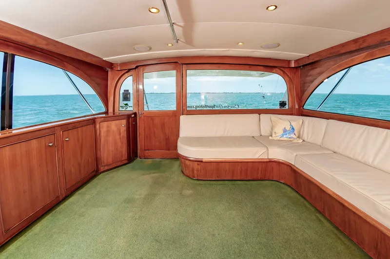 Carolina Girl Yacht Photos Pics Luxurious 1993 Jarrett Bay Convertible yacht interior with wood paneling and ocean view.