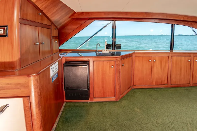 Carolina Girl Yacht Photos Pics Interior of 1993 Jarrett Bay Convertible yacht with wooden cabinets and ocean view.