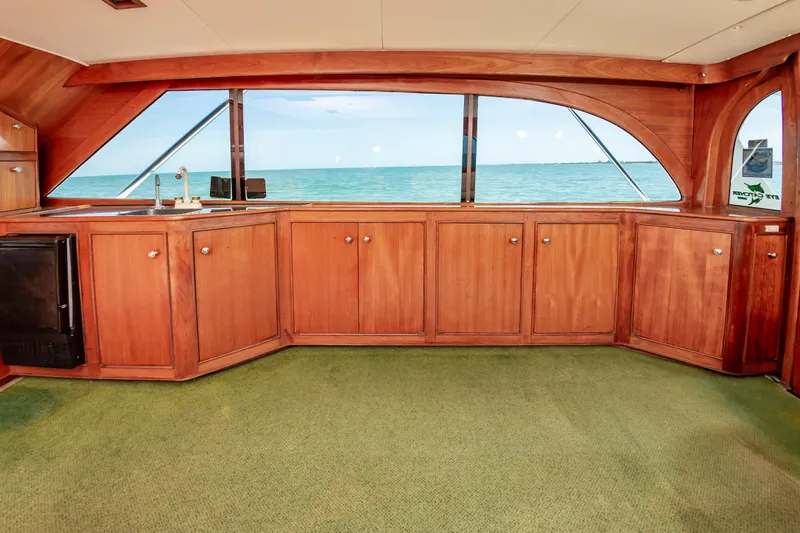 Carolina Girl Yacht Photos Pics Interior of 1993 Jarrett Bay Convertible yacht with wooden cabinetry and ocean view.