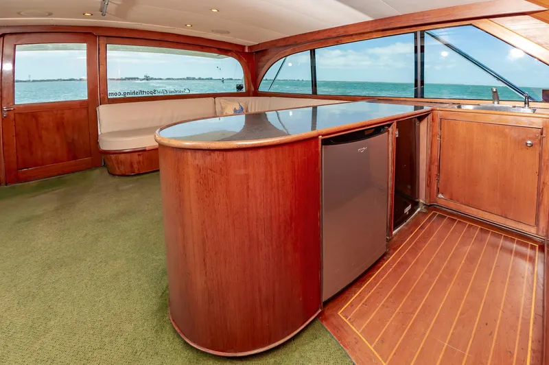 Carolina Girl Yacht Photos Pics Luxurious 1993 Jarrett Bay Convertible yacht interior with wood finishes and ocean view.