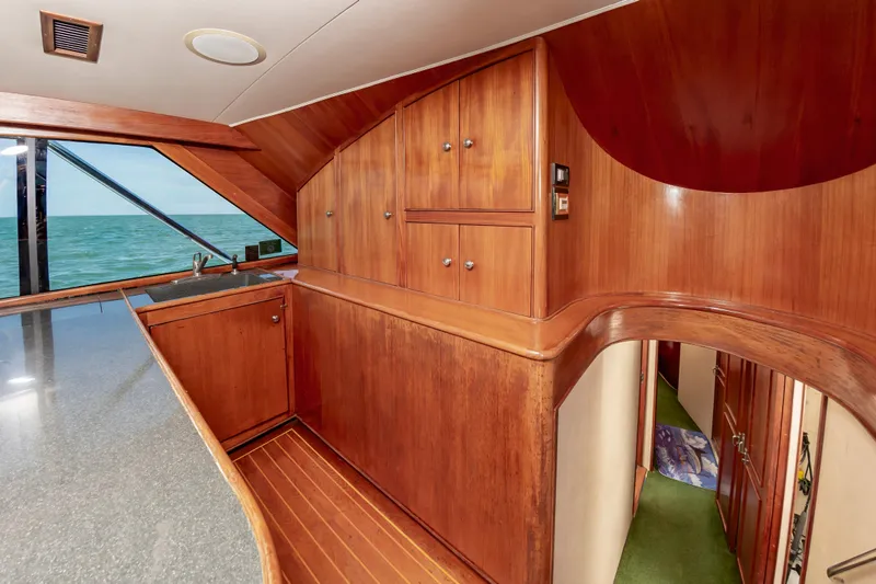 Carolina Girl Yacht Photos Pics Interior of 1993 Jarrett Bay Convertible yacht with wooden cabinetry and ocean view.