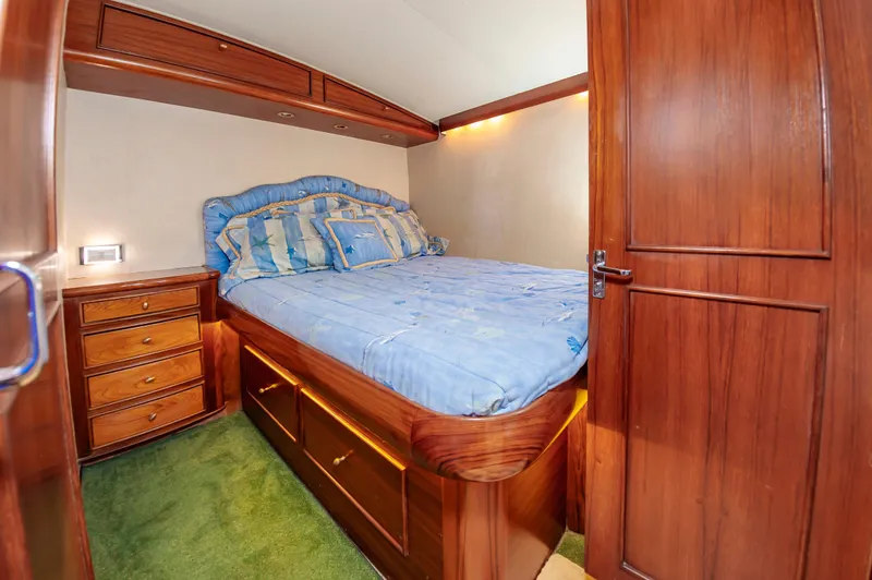 Carolina Girl Yacht Photos Pics Luxurious cabin interior of 1993 Jarrett Bay Convertible yacht with wooden furnishings.