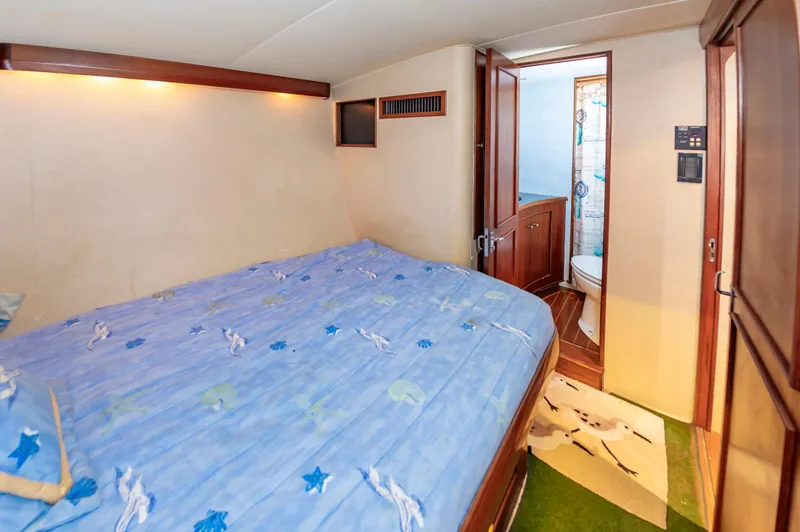 Carolina Girl Yacht Photos Pics Bedroom and bathroom interior of a 1993 Jarrett Bay Convertible yacht.