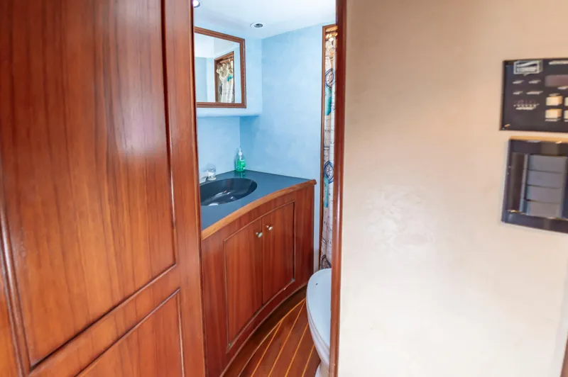 Carolina Girl Yacht Photos Pics 1993 Jarrett Bay Convertible yacht bathroom with wooden cabinetry and modern fixtures.