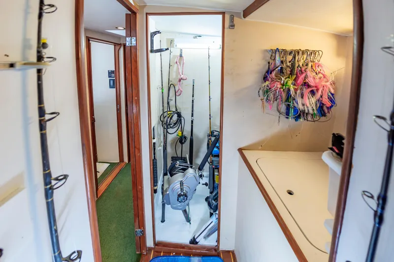 Carolina Girl Yacht Photos Pics 1993 Jarrett Bay Convertible interior with fishing rods and colorful lures.
