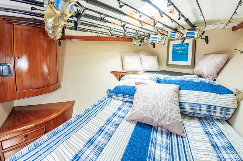 Carolina Girl Yacht Photos Pics Cozy cabin interior of 1993 Jarrett Bay Convertible with fishing rods and nautical decor.