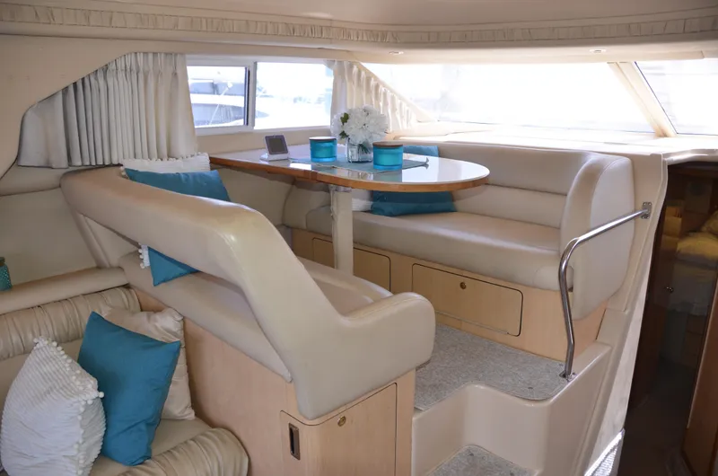 Don't Blink Yacht Photos Pics Luxurious interior of 2000 Sea Ray 400 Sedan Bridge with elegant seating and dining area.